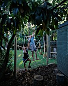 SPIDERS WEB ROPE CLIMBING FRAME: STEVEN AND DANIEL JAMES CLIMBING ON THE WEB
