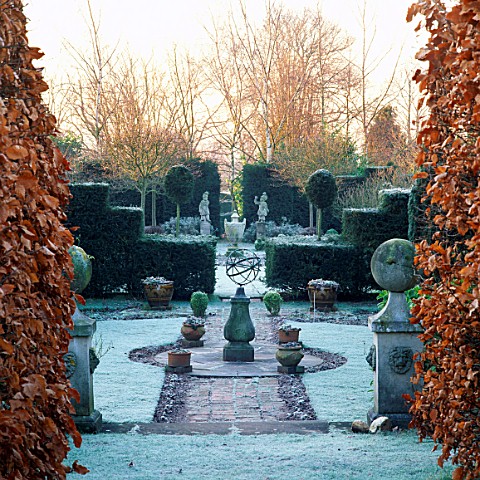 ARMILLARY_SPHERE_AT_CENTRE_OF_FORMAL_JUBILEE_GARDEN_IN_FROST__SIR_ROY_STRONGS_GARDEN__HEREFORD___WOR