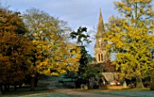THE CHURCH AND DRIVE IN AUTUMN  WITH A HUGE SPECIMEN OF GINKGO BILOBA ON THE RIGHT. ENGLEFIELD HOUSE  BERKSHIRE