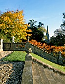VIEW TOWARDS THE CHURCH FROM THE STEPS AT ENGLEFIELD HOUSE  BERKSHIRE  WITH RHUS TYPHINA AND STONE BALUSTRADE