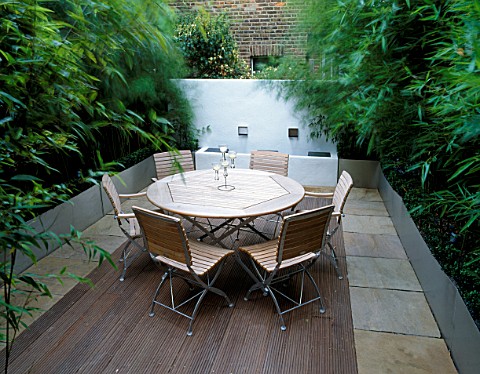 ROOF_TERRACE_WITH_DECKING__WOODEN_TABLE_AND_CHAIRS__GALVANISED_METAL_CONTAINERS_WITH_BAMBOO__WHITEWA