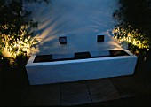 ROOF TERRACE WITH DECKING AT NIGHT:  WHITEWASHED WALL AND WATER FEATURE: DESIGNERS: WYNNIATT-HUSEY CLARKE