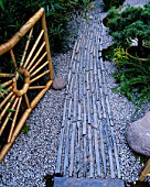 SPIDERS WEB BAMBOO GATE AND PATH OF GRAVEL AND STONE. WORLD OF KOI GARDEN  CHELSEA 2002