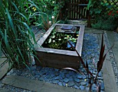 RAISED WOODEN POND WITH WATERLILIES AND SLATE WATER FEATURE. DESIGN BY GEO DESIGNS
