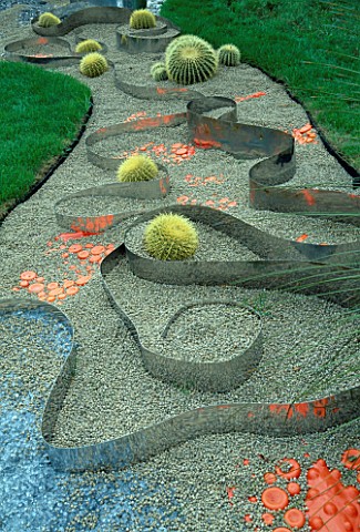 GRAVEL__ORANGE_PLASTIC__METAL_STRIPS_AND_ECHINOCACTUS_IN_THE_HAPPENING_GARDEN_BY_TONY_HEYWOOD_AT_THE