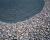 COBBLES AND RAKED GRAVEL IN THE WATER GARDENS  LONDON: THE SWIMMER  A JAPANESE INSPIRED LANDSCAPE BY TONY HEYWOOD OF CONCEPTUAL GARDENS