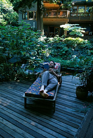 MIKE_DRYFOOS_RELAXES_ON_THE_DECK_BESIDE_THE_KOI_POND_DESIGNERS_ILGA_JANSONS_AND_MIKE_DRYFOOS__SEATTL