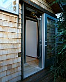 THE OUTDOOR SHOWER SEEN FROM OUTSIDE WITH THE DOOR OPEN: DESIGNED BY BOB SWAIN  SEATTLE  USA
