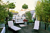 ROOF GARDEN WITH DECKING  WHITE CHAIRS AND GALVANISED POTS PLANTED WITH CLIPPED BAY TREES. DESIGNERS: PATRICK WYNNIAT - HUSEY AND PATRICK CLARKE