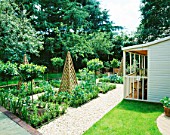 FAMILY POTAGER BY CLARE MATTHEWS: GRAVEL  WOODEN OBELISKS  CLIPPED BOX AND BAY AND A SUMMERHOUSE
