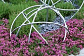PINK THYME WITH METAL GLOBES. TATTON PARK 2002  DESIGNER: MYFANWY JONES