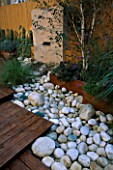 ROOF GARDEN WITH BAMBOO FENCING   WHITE BOULDERS  RED CEDAR DECKING AND WATER FEATURE: DESIGN BY ALISON WEAR ASSOCIATES