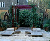 ROOF GARDEN: BARLEYCORN GRAVEL  BAMBOO CHAIRS  RED PERGOLA AND RUSTED STEEL SCULPTURE: DESIGN BY ALISON WEAR ASSOCIATES