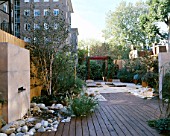 ROOF GARDEN: BAMBOO FENCE  WATER FEATURE  WHITE BOULDERS  RED CEDAR DECK  BAMBOO SEATS AND BARLEYCORN GRAVEL: DESIGN BY ALISON WEAR ASSOCIATES