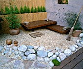 ROOF GARDEN: BAMBOO FENCE  WHITE BOULDERS  RED CEDAR DECK AND SEATS  RENDERED WALL WITH WINDOW AND BESOM BROOM: DESIGN BY ALISON WEAR ASSOCIATES