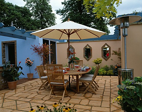 HAMPTON_COURT_2002__MARSHALLS_GARDEN_MEDITERRANEAN_STYLE_PATIO_WITH_WOODEN_TABLE_AND_CHAIRS