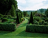 PETTIFERS GARDEN  OXFORDSHIRE  DESIGNER: GINA PRICE: THE LOWER PARTERRE IN SUMMER WITH THE COUNTRYSIDE BEYOND