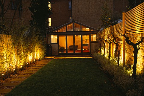 GARDEN_DESIGNED_BY_CLAIRE_MEE__LIT_UP_AT_NIGHT_SUMMERHOUSE__BAMBOO_AND_OLIVE_TREES
