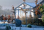 THE CONSERVATORY IN WINTER WITH A SCULPTURE BY HELEN SINCLAIR AT THE LANCE HATTATT DESIGN GARDEN AT ARROW COTTAGE  HEREFORDSHIRE