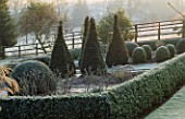 FROST COVERS THE LOWER PARTERRE WITH YEW AND BOX SHAPES AT PETTIFERS GARDEN  OXFORDSHIRE
