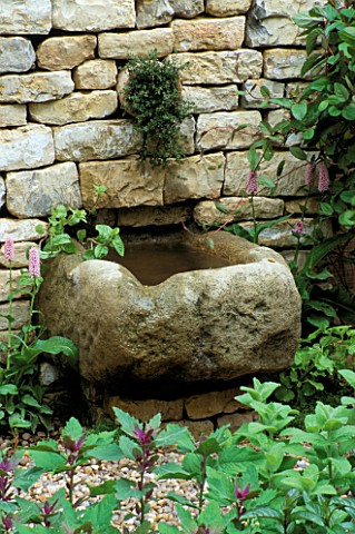 STONE_TROUGH_WATER_FEATURE_SET_INTO_DRY_STONE_WALL_IN_THE_HERB_SOCIETYS_GARDEN__CHELSEA_2003_GARDEN_