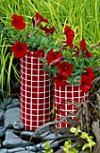 RED MOSAIC CONTAINER PLANTED WITH PETUNIA SURFINIA RED. DESIGNER: CLARE MATTHEWS