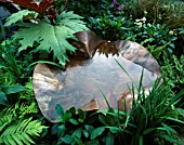 COPPER WATER FEATURE IN A GARDEN DESIGNED BY MARK GREGORY
