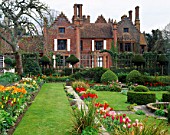 CLASSIC VIEW OF THE HOUSE FROM THE TULIP FILLED SUNKEN GARDEN AT CHENIES MANOR  BUCKINGHAMSHIRE