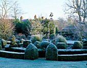 WEST GREEN HOUSE GARDEN  HAMPSHIRE: FROSTED CLIPPED BOX SURROUNDS AN OLD WELL - HEAD IN THE WALLED GARDEN IN WINTER