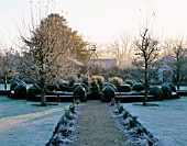 WEST GREEN HOUSE GARDEN  HAMPSHIRE: FROSTED CLIPPED BOX SURROUNDS AN OLD WELL - HEAD IN THE WALLED GARDEN IN WINTER