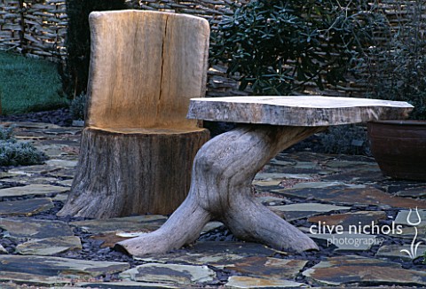 A_PLACE_TO_SIT_WOODEN_SEAT_AND_TABLE_ON_STONE_FLOOR_JOHN_MASSEYS_GARDEN__WORCESTERSHIRE
