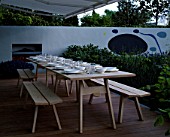 CHELSEA FLOWER SHOW 2004: LAURENT PERRIER/HARPERS & QUEEN GARDEN BY TERENCE CONRAN AND NICOLA LESBIREL. DINING DECK BESIDE THE PAVILION KITCHEN WITH WOODEN TABLE AND CHAIRS