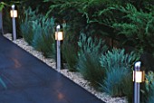 CHELSEA 2004: NOW AND ZEN GARDEN: PATH BORDERED BY GRASSES LIT UP AT NIGHT