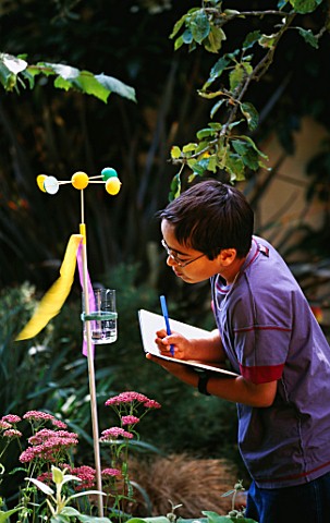 DESIGNER_CLARE_MATTHEWS__WEATHER_STATION_PROJECT__BOY_MAKING_NOTES_ABOUT_RAINFALL