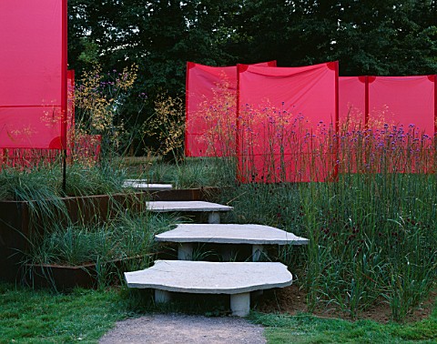 STEPPING_STONE_STEPS___VERBENA_BONARIENSES_AND_STIPA_GIGANTEA_IN_FRONT_OF__RED_SEMIPERMANTENT_SCREEN