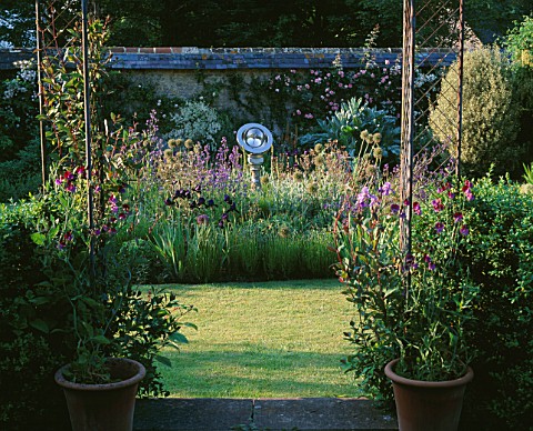 ANGEL_COLLINS_GARDEN_SUNDIAL_BY_DAVID_HARBER_IN_BED_WITH_IRISES__ANCHUSA_AZUREA_LODDON_ROYALIST__ALL