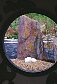 DESIGNERS R. KETCHELL AND JACQUIE BLAKELEY: MOMOTARO (JAPANESE) GARDEN - VIEW THROUGH MOON GATE TO LARGE ROCK FOCAL POINT