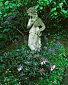 DESIGNER: SHEILA STEDMAN - FRONT GARDEN - STATUE SURROUNDED BY BLUEBELLS AND RHODODENDRONS