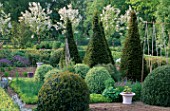 PETTIFERS GARDEN  OXFORDSHIRE:THE PARTERRE IN SPRING WITH MALUS HUPEHENSIS BEHIND