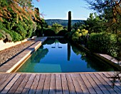 LA CHABAUDE  FRANCE: DESIGNER - PHILIPPE COTTET: THE SWIMMING POOL WITH DECKING AND COUNTRYSIDE BEYOND