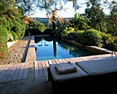 LA CHABAUDE  FRANCE: DESIGNER - PHILIPPE COTTET: THE SWIMMING POOL WITH DECKING  SUNLOUNGERS AND COUNTRYSIDE BEYOND