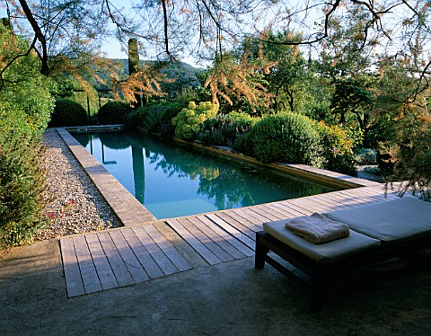 LA_CHABAUDE__FRANCE_DESIGNER__PHILIPPE_COTTET_THE_SWIMMING_POOL_WITH_DECKING__SUNLOUNGERS_AND_COUNTR