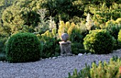 LA CHABAUDE  FRANCE: DESIGNER - PHILIPPE COTTET: PLANTING OF YUCCA GLORIOSA AND EUPHORBIA BESIDE PATH WITH STONE BALL AND PEDESTAL