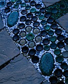 RECYCLED BOTTLES  GLASS PEBBLES ON CIRCULAR PAVED PATH. DESIGNER: DAVID CHASE