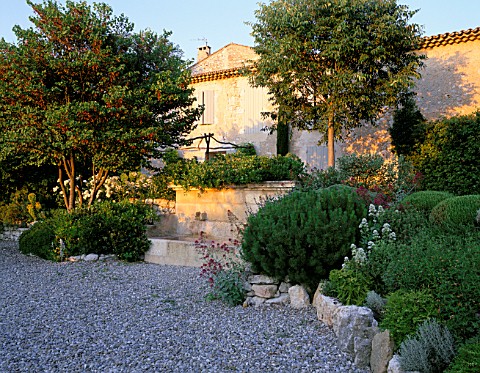 LA_CHABAUDE__FRANCE_DESIGNER__PHILIPPE_COTTET_GRAVEL_TERRACE_AND_STONE_WATER_FEATURE_BY_THE_HOUSE