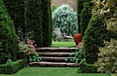THE ABBEY HOUSE  WILTSHIRE: VIEW OF PARTERRE WITH CLIPPED YEW  BOX AND HOLLY AND CERAMIC SCULPTURE DARK VASE BY CHRISTINE ANN RICHARDS