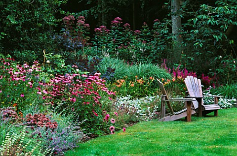 LAWN__ADIRONDACK_CHAIRS_AND_BORDER_PLANTED_WITH_NEPETA__ECHINACEA_AND_EUPATORIUM_DESIGNER_DUNCAN_HEA