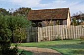 WOODEN FENCE AND GARDEN BUILDING. MARCHANTS HARDY PLANTS  SUSSEX
