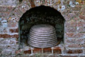 PACKWOOD HOUSE  WARWICKSHIRE: BEE SKEP IN THE WALLED GARDEN