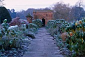 PACKWOOD HOUSE  WARWICKSHIRE  IN WINTER: FROST ON THE DOUBLE BORDERS WITH PHORMIUMS AND EUPHORBIA MILLIFERA
